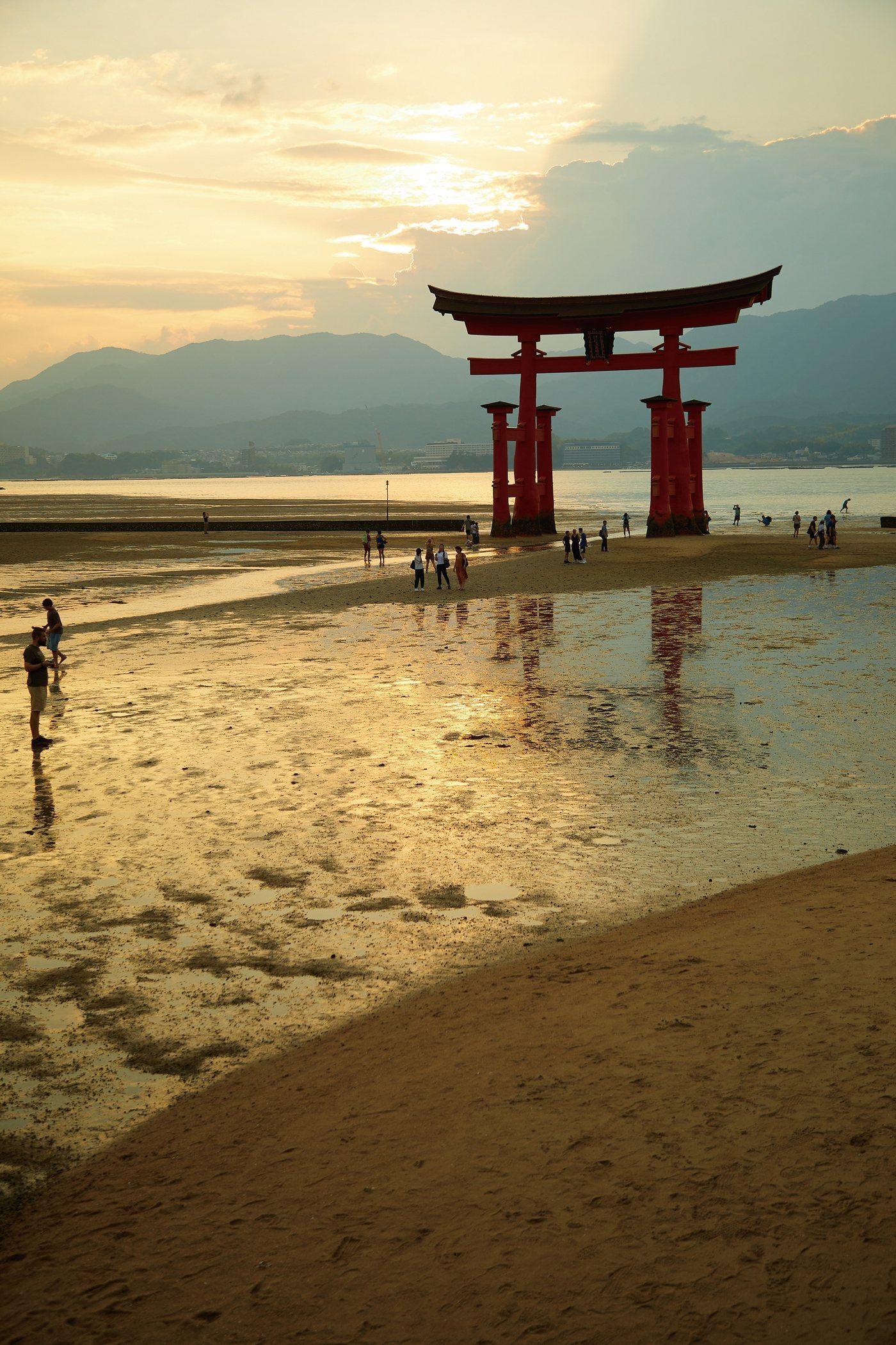 The great torii silhouetted over golden tidal flats at dusk