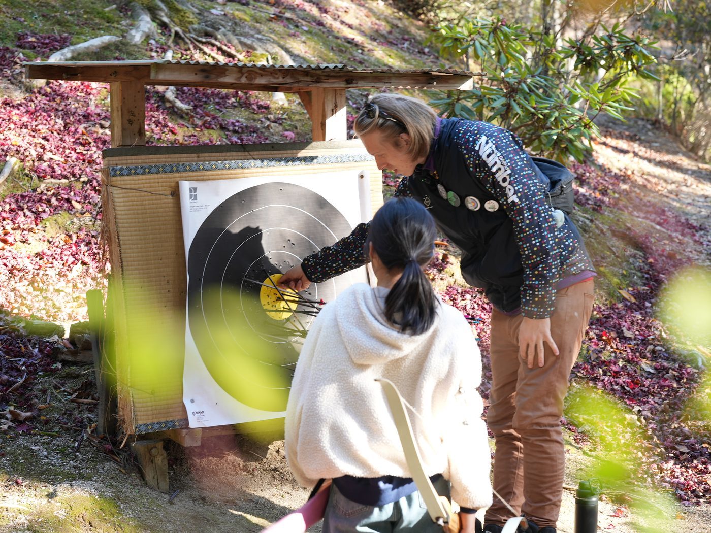 An archery target standing among autumn leaves